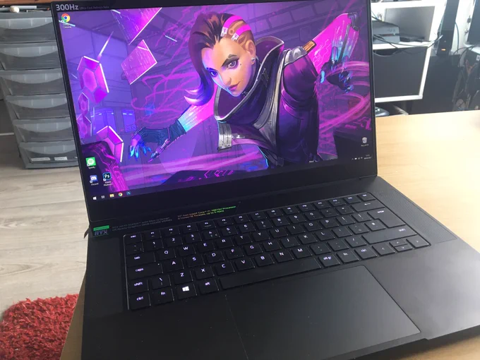 Open laptop, with desktop image of Sombra from Overwatch