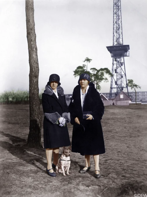 women in roughly 1920's Germany with their dog, colorized