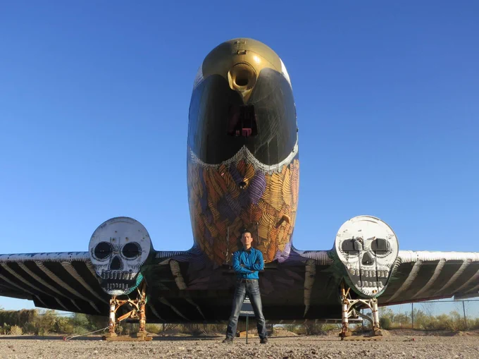 Roger Cheng stands in front of "Phoenix of Metal"
