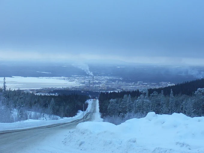 A photo of the town of Kandalaksha, seen from a distance. Part of the Kandalaksha Gulf is visible in the left part of the photo