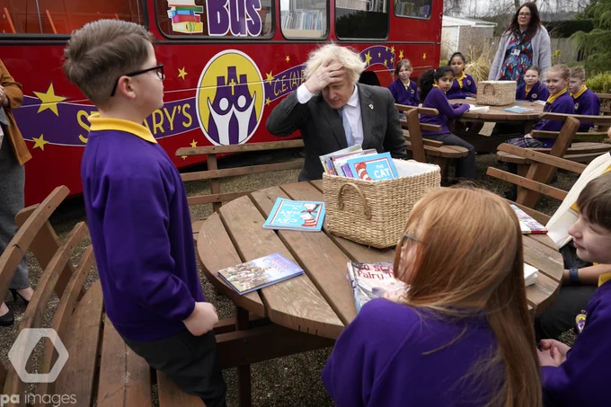 Prime Minister Boris Johnson joins a Year 4 reading lesson outside during a visit to St Mary's CE Primary School in Stoke-on-Trent, Staffordshire, to see how they are preparing for students to return. 