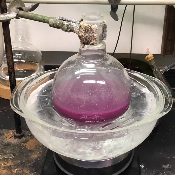 A 1000 mL round bottom with a bright purple opaque solution inside