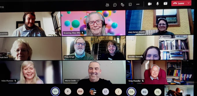 Image shows a Team screen with meeting attendees looking at their cameras, smiling
