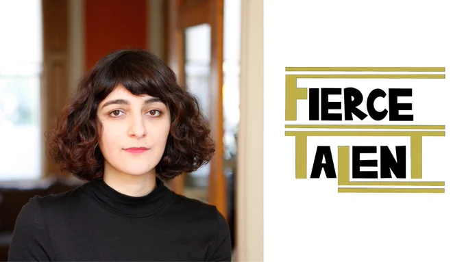 A woman is staring straight at the camera, she has above shoulder length hair and is wearing a black top. The background is blurred. To the right of her is a gold and black logo reading "Fierce Talent"