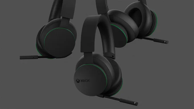 Three floating Xbox Wireless Headsets on a grey background.