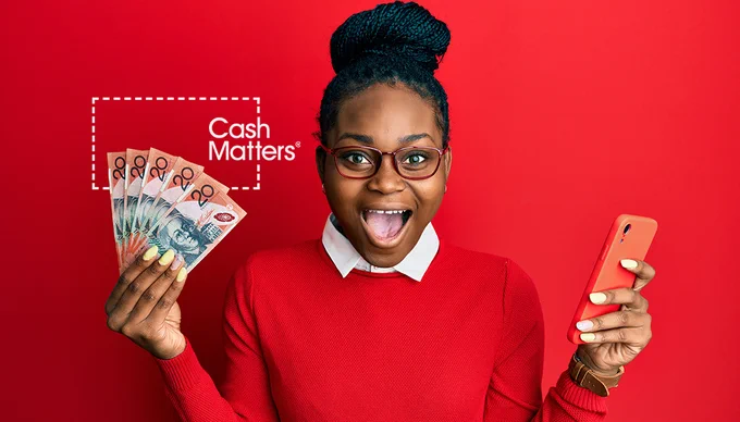 Cash Matters: A joyful woman holding a fan of Australian dollars in one hand and a phone in the other