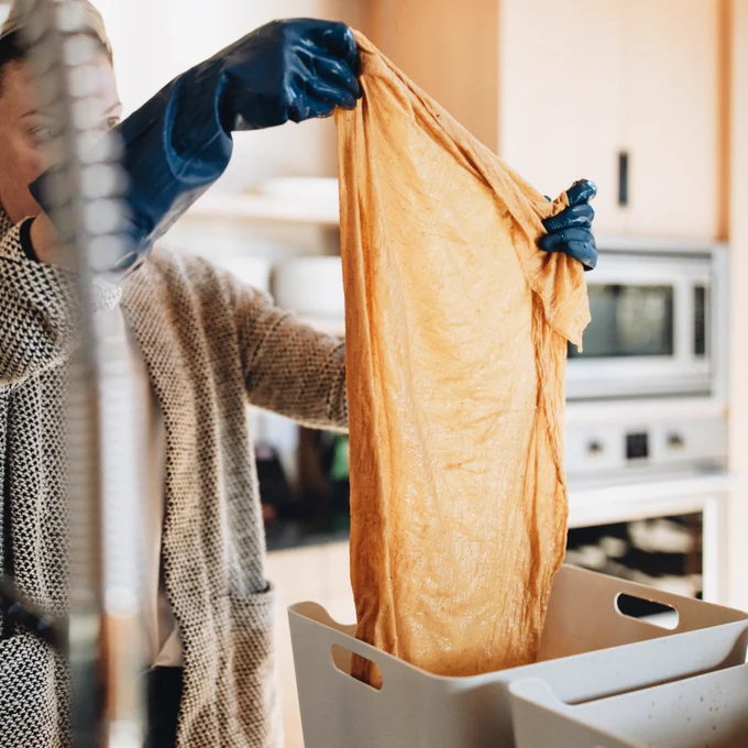 Megan holding up her naturally dyed fabric