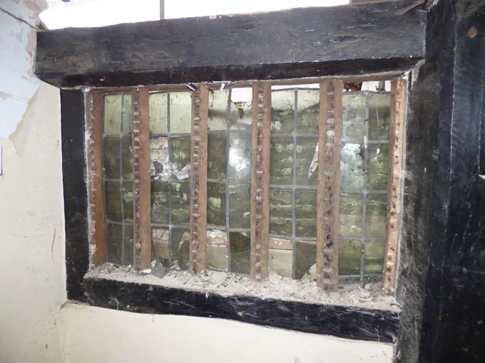 The old window discovered within the wall of the cottage.