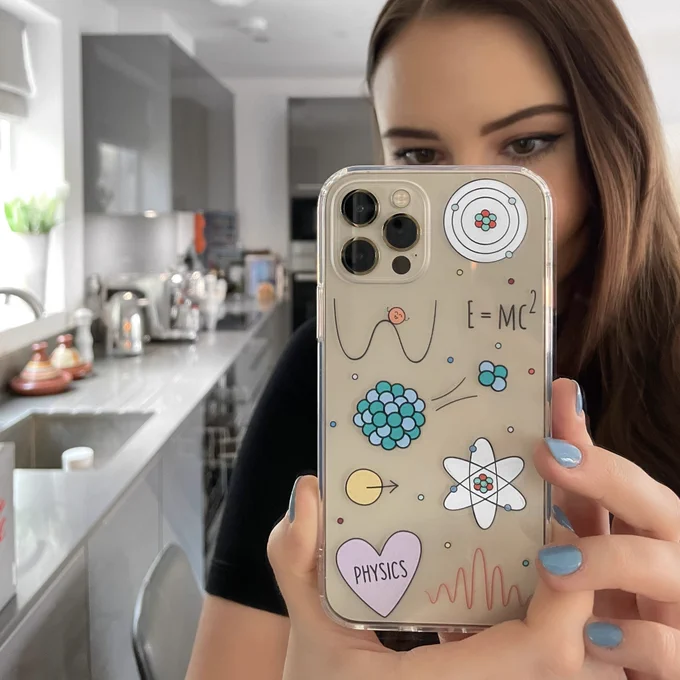 Mirror selfie showcasing a phone case with a physics design.