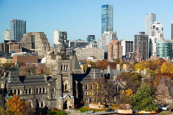 University College at the University of Toronto in the fall with the cityscape in the background.