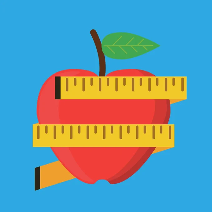 Picture of red apple with yellow tape measure wrapped around it