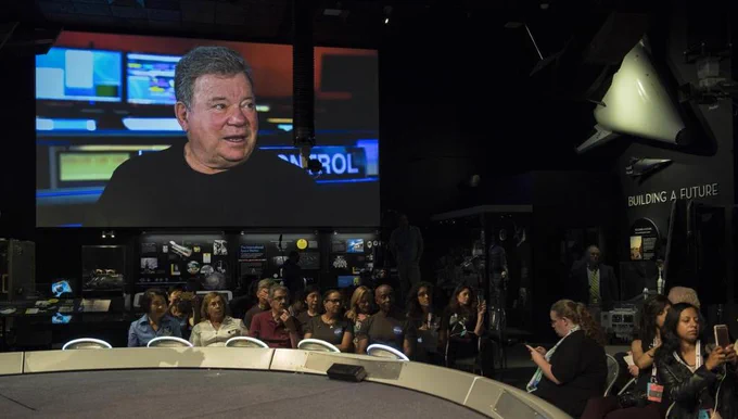 William Shatner of Star Trek is seen on a live feed from NASA's Jet Propulsion Laboratory, giving the order to send a message into deep space.