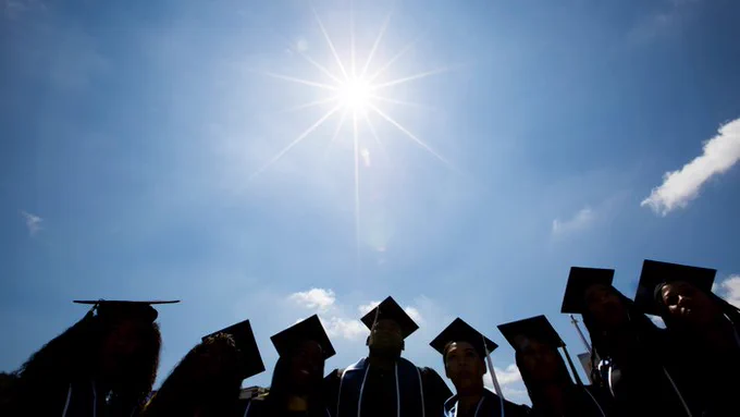 graduate silhouettes in the sunlight