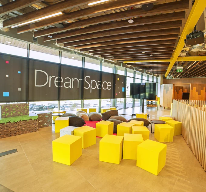 Photo of an interior common area at the Microsoft Dublin campus, featuring yellow blocks for sitting.