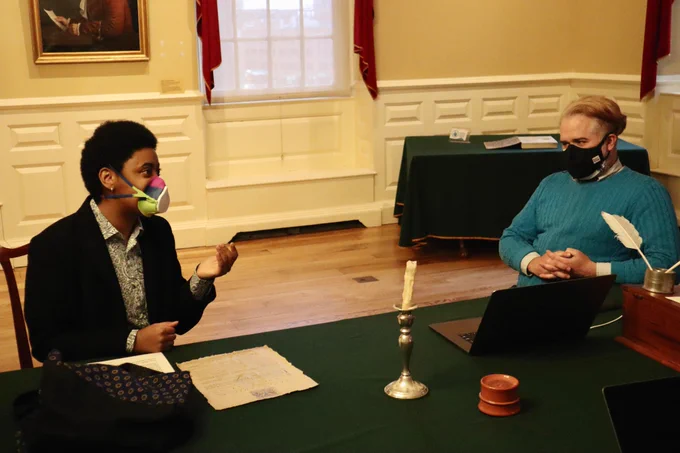Kendra and Rob sitting at the table in the Council Chamber at the Old State House during a writing session for Tea Party Tonight!