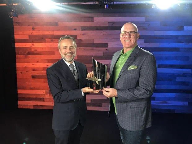 Photo of President Barry Corey presenting an award