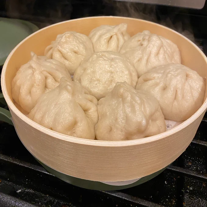 baozi in a steamer basket. they aren't well shaped, but they look tasty.