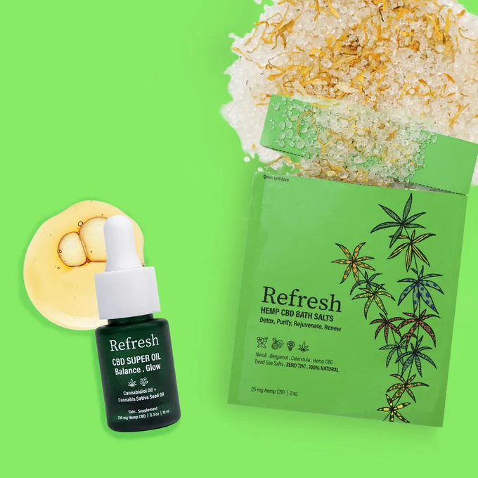 bath salts with CBD in a green pouch. a green bottle with white dropper of CBD oil. both are on green background