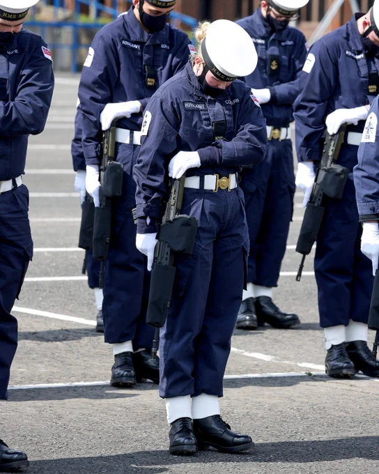 A member of the Guard of Honour bows her head during practice drills