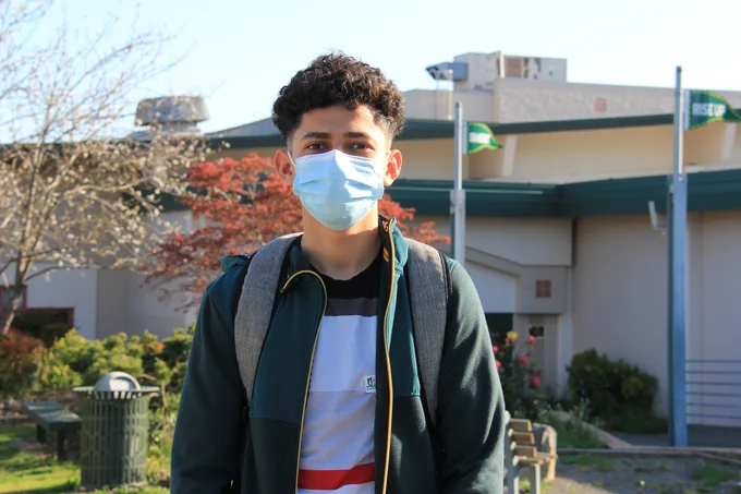 EHS student in front of gym