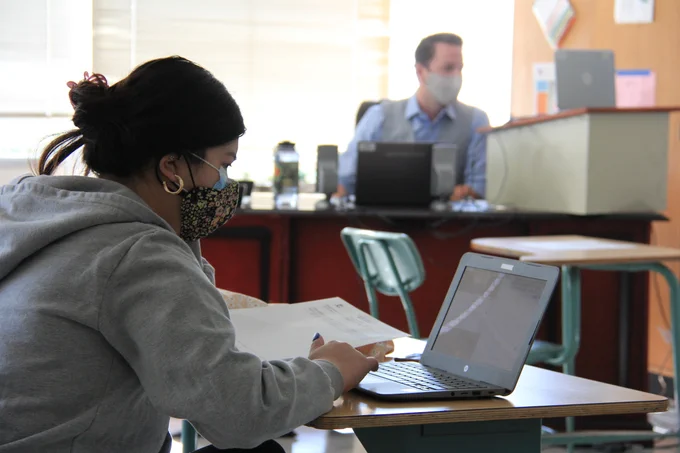 Student in classroom with teacher