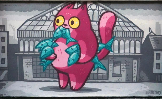 New mural of a pink cat eating fish outside the Manchester Craft and Design Centre