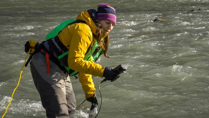 Scientist sampling a river