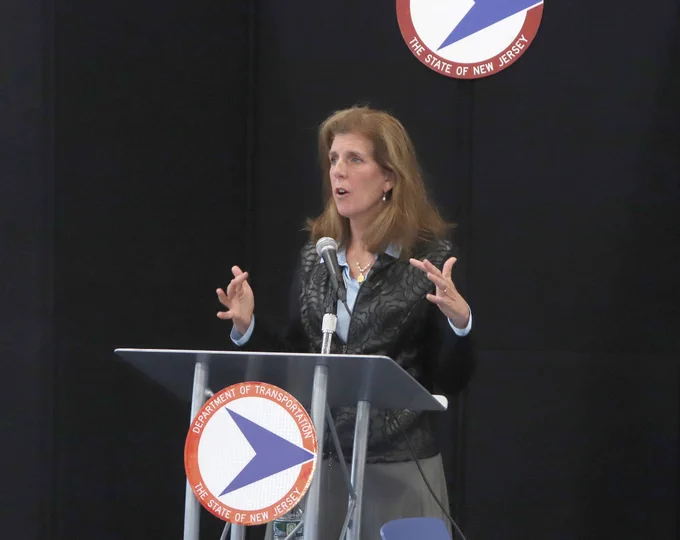 Stephanie Hoopes stands at a NJ Department of Transportation podium and addresses her audience