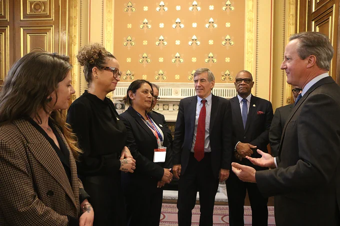 Chief Minister Julie Thomas stood opposite, and in discussion with, Foreign Secretary David Cameron