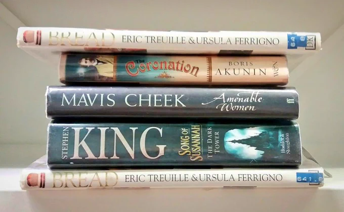 A sandwich made of books. The spines read Bread, Coronation, Cheek, King, Bread. 