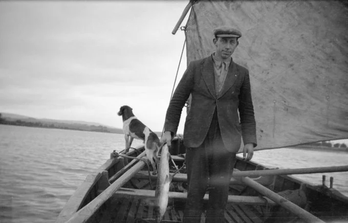 Harry Madill recorded interviews with a number of individuals that worked on traditional boats. This photo of a salmon coble operating on the Foyle fishery features Eddie Moore and Jombo the dog. (Photo courtesy of A. Lyttle).