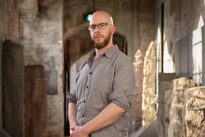 Dr Neil Coughlan standing in the corridor of UCC's Quad. Image: UCC TV's Rubén Tapia.