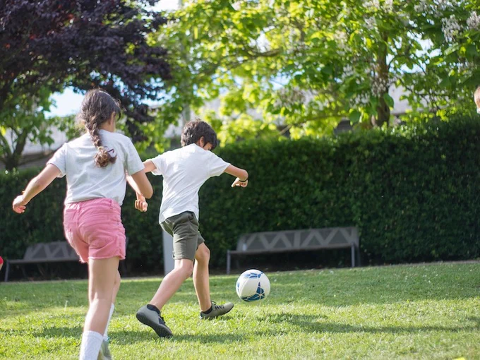 Two kids playing soccer