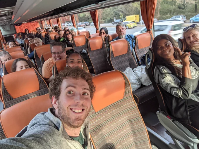Smiling selfie on the bus full of speakers and organizers