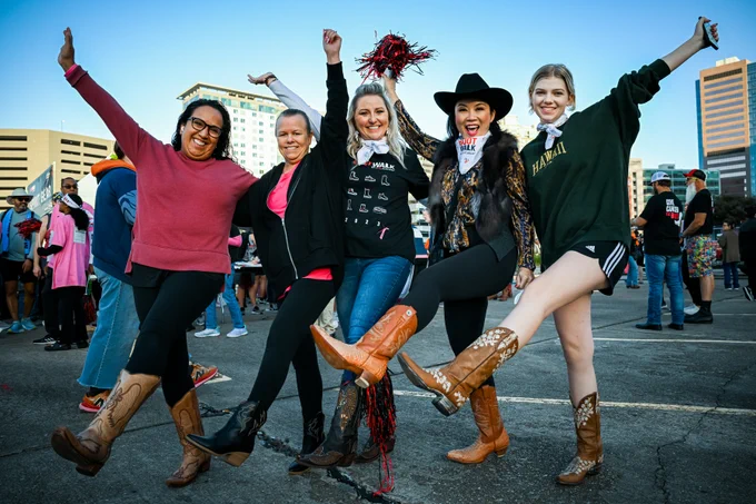 people in cowboy boots smiling at the camera