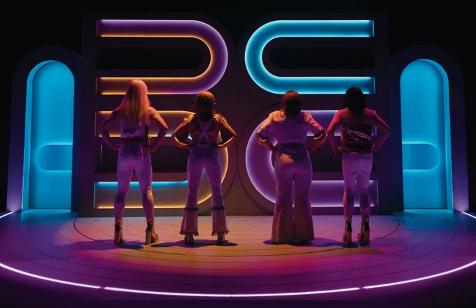 The Way Old Friend's Do's cast stood with their backs turned away from the audience and stood facing the ABBA shaped set prop. The cast (from left to right) are Peter, Rose, Mrs Campbell, and Edward.