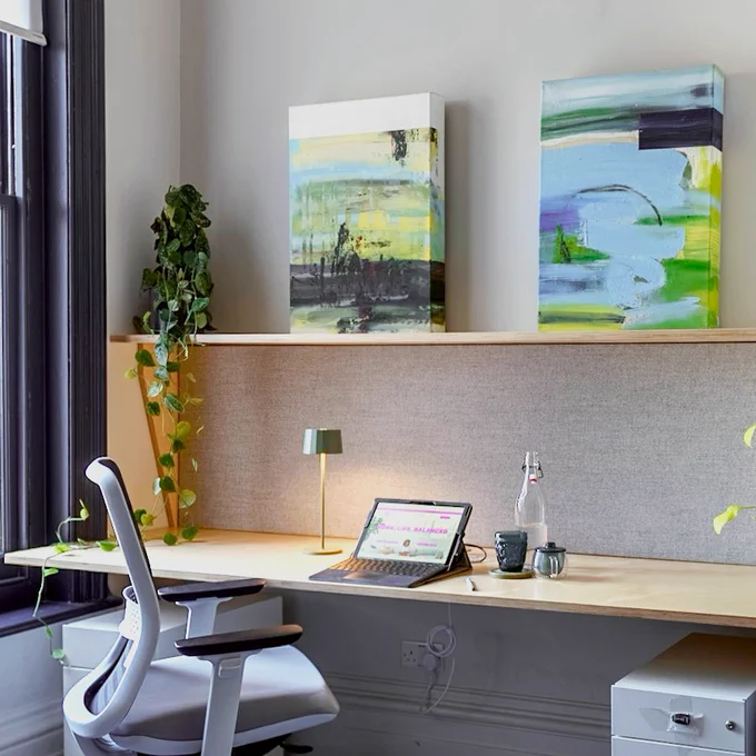 A dedicated desk set up with a small laptop. 