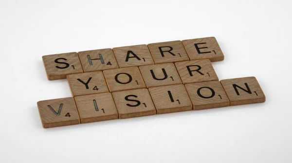 The words share your vision spelled out with scrabble tiles