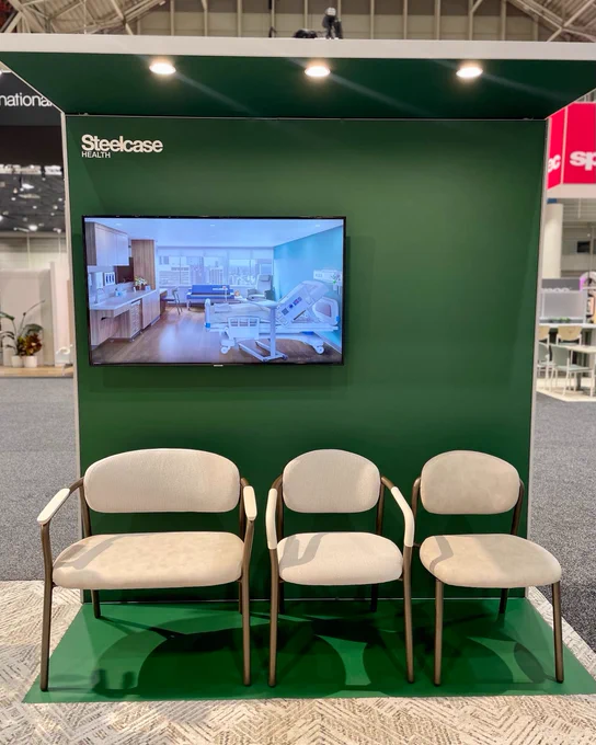 Three Radia side chairs in the Steelcase showroom at Healthcare Design Conference show the different sizes and arm configurations of Radia.