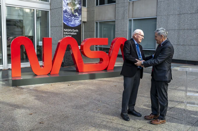NASA Associate Administrator Bob Cabana, right, shakes hands with Richard Danne after awarding him the Exceptional Public Achievement Medal for his outstanding achievement in creating the NASA worm logotype, Monday, Nov. 6, 2023, at the Mary W. Jackson NASA Headquarters building in Washington.  Photo Credit: (NASA/Keegan Barber)