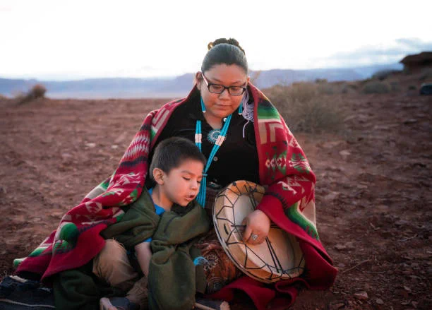 AIAN mother and son sitting outside
