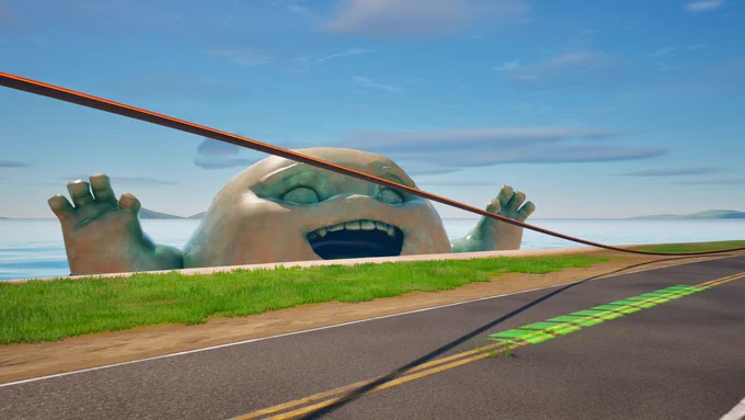 Island race course with Daruma Statute peaking through the ocean .
