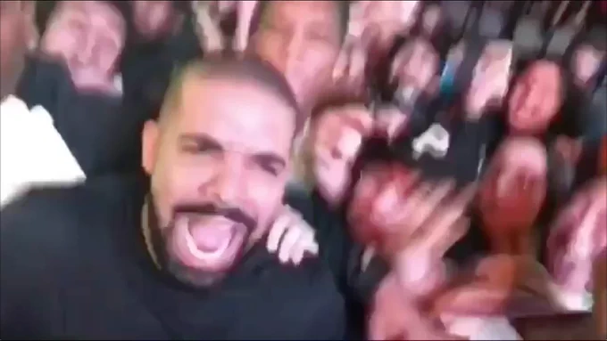 Drake yelling in excitement alongside a crowd
