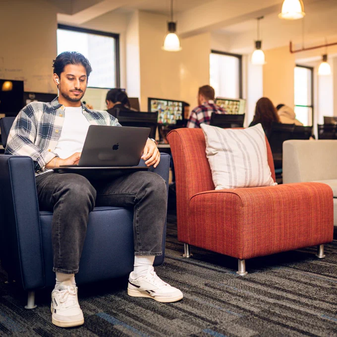 A man works from his laptop at Zip Code Wilmington.