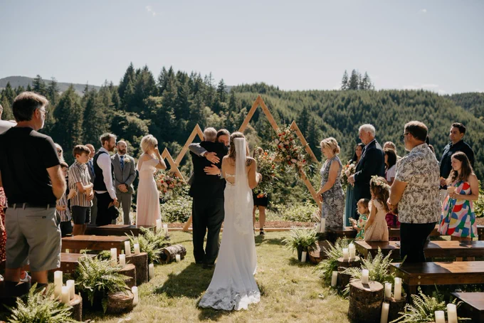 Dad giving bride away, groom embraces new dad