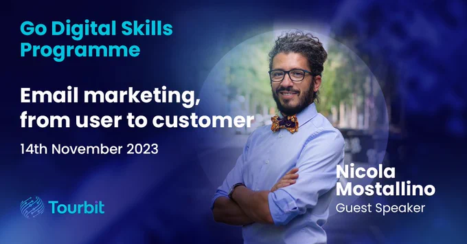 Promotional banner for the Go Digital Skills Programme featuring an event titled 'Email marketing, from user to customer' scheduled for 14th November 2023. Image shows a male guest speaker, Nicola Mostallino, with glasses and a stylish bow tie, smiling and standing with arms crossed. The background is a blurred cityscape, with the Tourbit logo and a blue to dark blue gradient overlay.