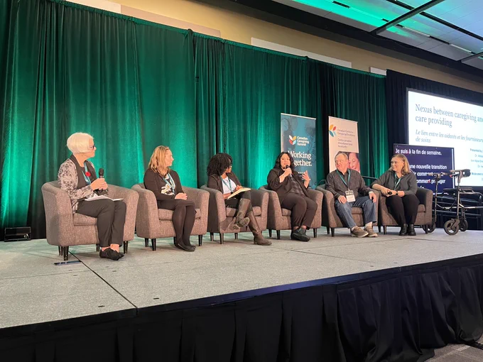 Panelists speaking on stage at the Nexus between caregiving and care providing session