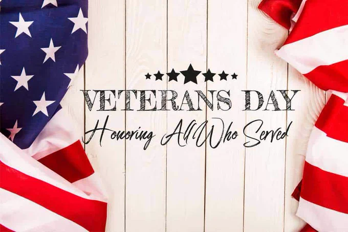 image of American flag with text "Veterans Day Honoring All Who Served
