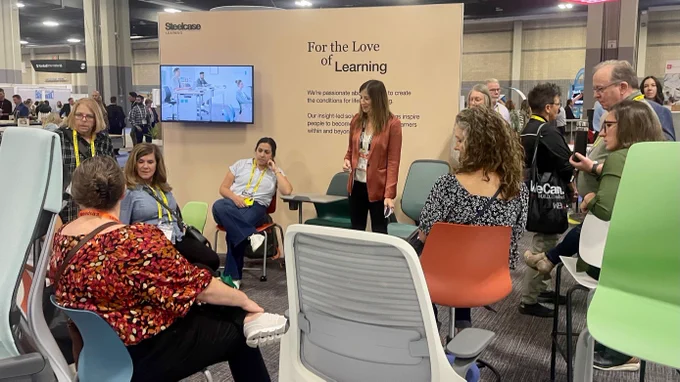 A group of attendees at the Educational Spaces Conference in Charlotte learn about Steelcase seating.