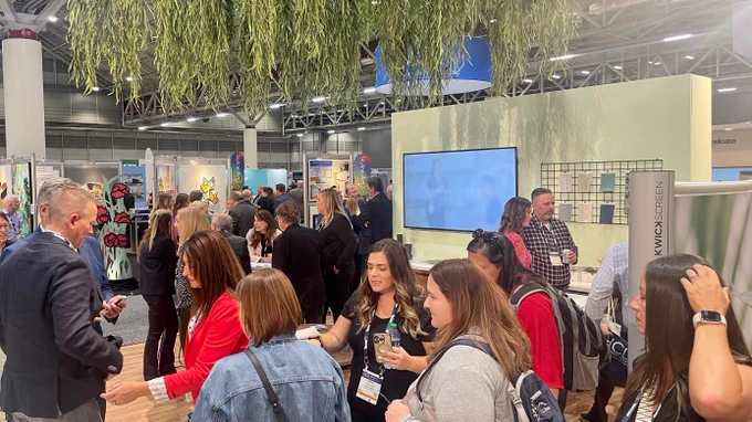 A group of attendees at the Steelcase Health booth at Healthcare Design Conference.